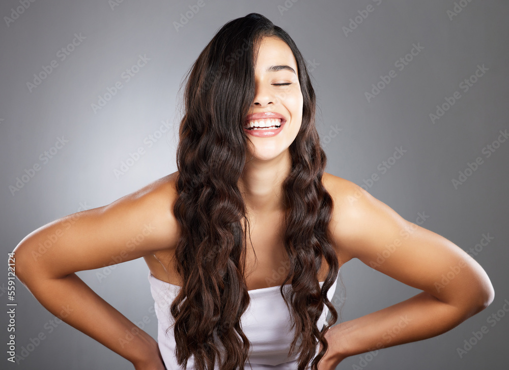 Fototapeta premium Hair care, woman and shine for beauty, natural glow and on grey studio background. Female, girl and hairstyle for wellness, confident and aesthetic for luxury grooming, treatment and salon routine.