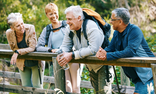 Elderly, people hiking and happy in park with fitness outdoor, relax on bridge while trekking in nature together. Health, wellness and hiker group, sport and active lifestyle motivation with cardio.