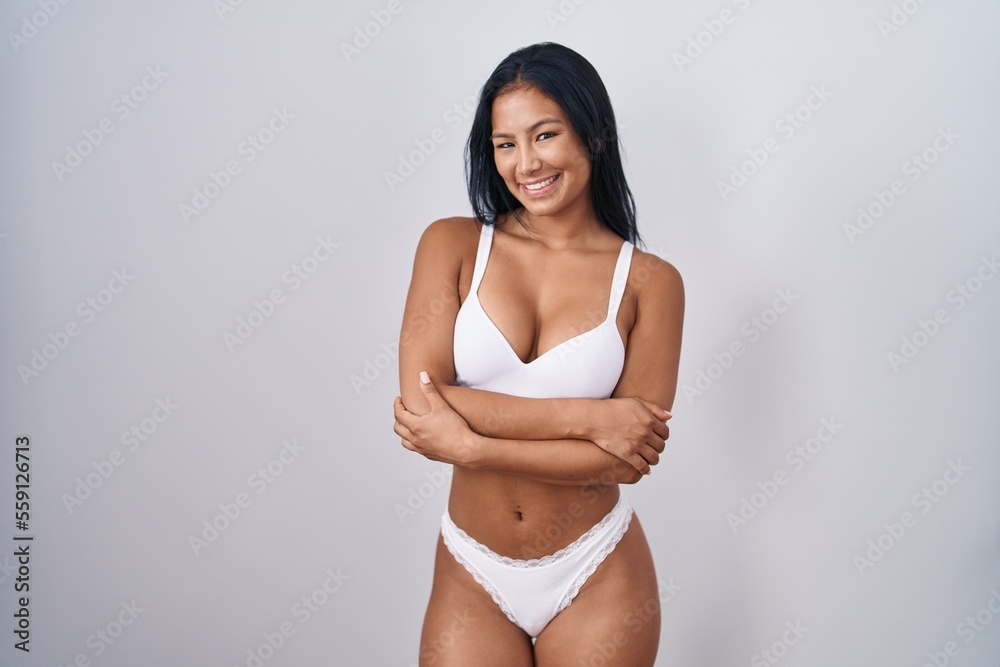 Fototapeta premium Hispanic woman wearing lingerie happy face smiling with crossed arms looking at the camera. positive person.