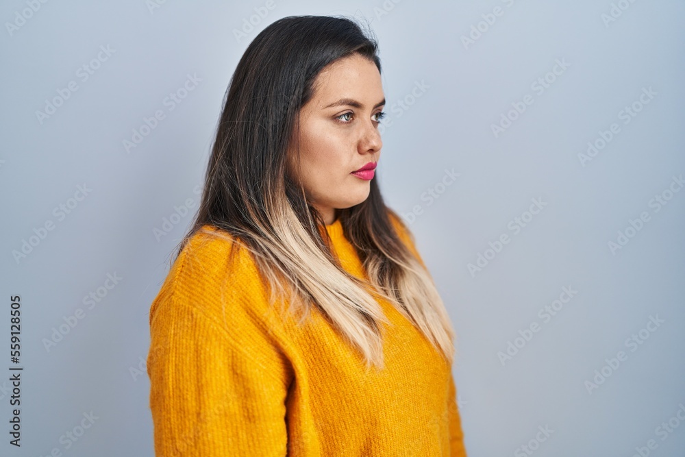 Young hispanic woman standing over isolated background looking to side, relax profile pose with natural face and confident smile. Young hispanic woman standing over isolated background looking to side, relax profile pose with natural face and confident smile.