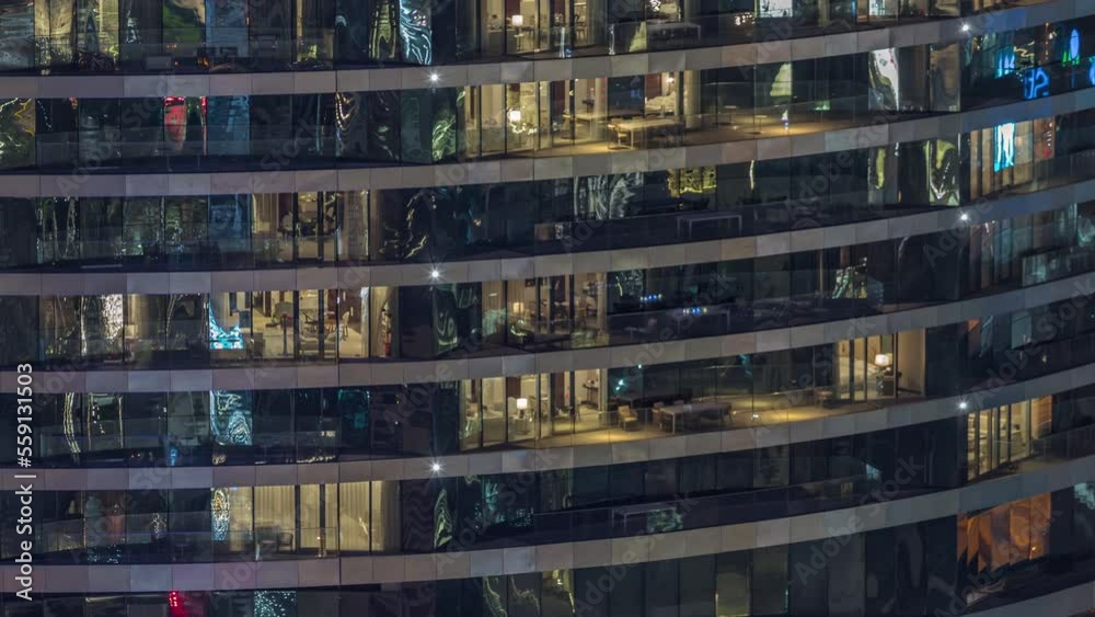Outside view of windows in apartments of a high class building at night timelapse. Glowing lights in skyscraper from metal and glass Outside view of windows in apartments of a high class building at night timelapse. Glowing lights in skyscraper from metal and glass