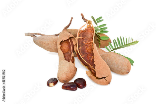 Tamarind fruits with green leaves isolated on white background © Kiran