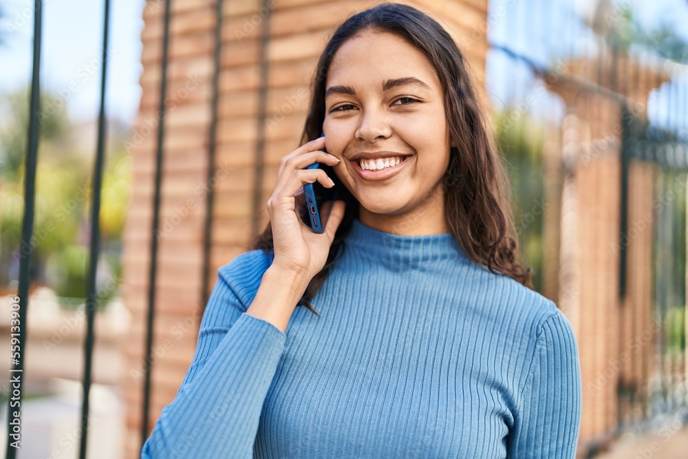 Young african american woman smiling confident talking on the smartphone at street Young african american woman smiling confident talking on the smartphone at street