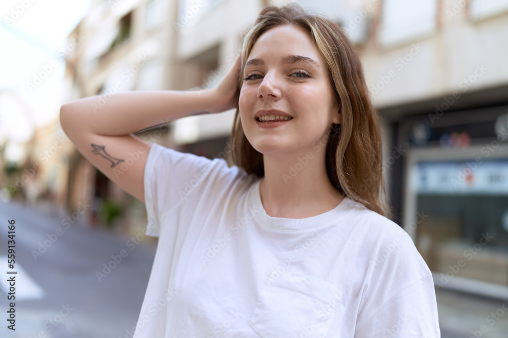 Young caucasian woman smiling confident standing at street