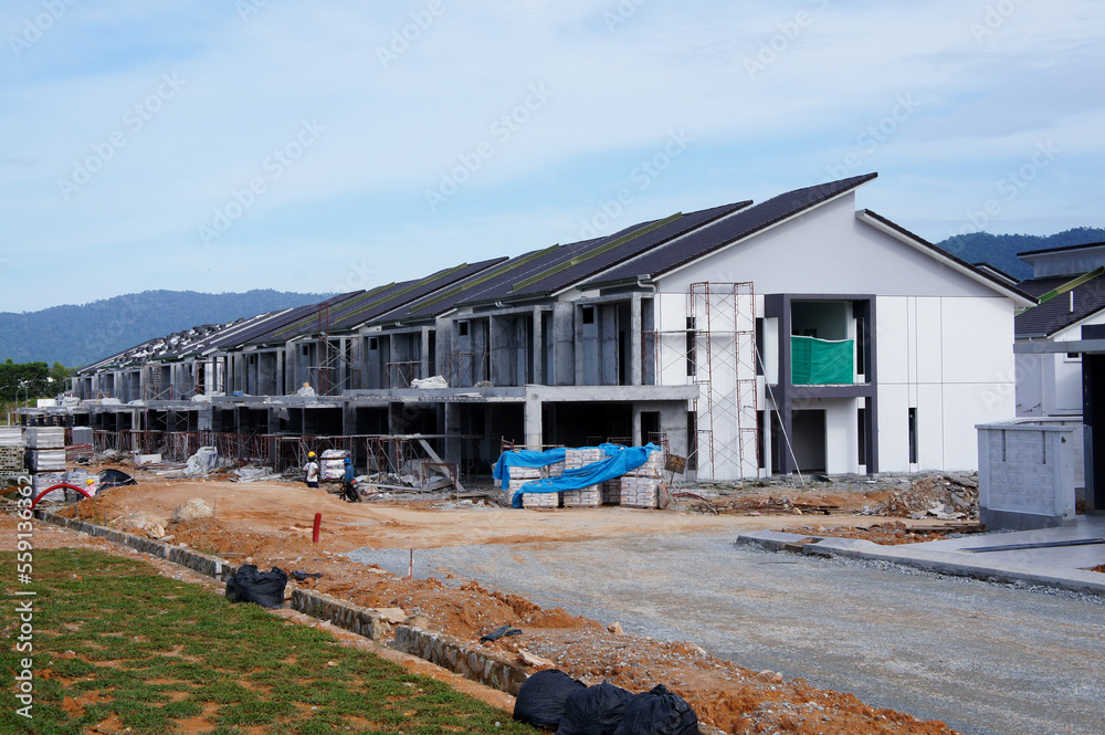 SELANGOR, MALAYSIA - JUNE 20, 2022: New double-story terrace house under construction in Malaysia. Have a wide porch. Utility facilities have also been built for future residents.