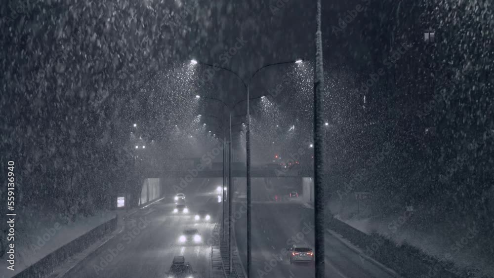Heavy snowfall or Snowstorm at night city road | highway. Dangerous snowfall. Heavy snowfall at night. Snowstorm under street lamp. Dangerous snowfall. Wrasaw, Poland.
