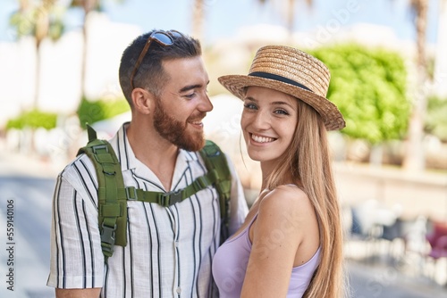 Man and woman tourist couple smiling confident hugging each other at street © Krakenimages.com