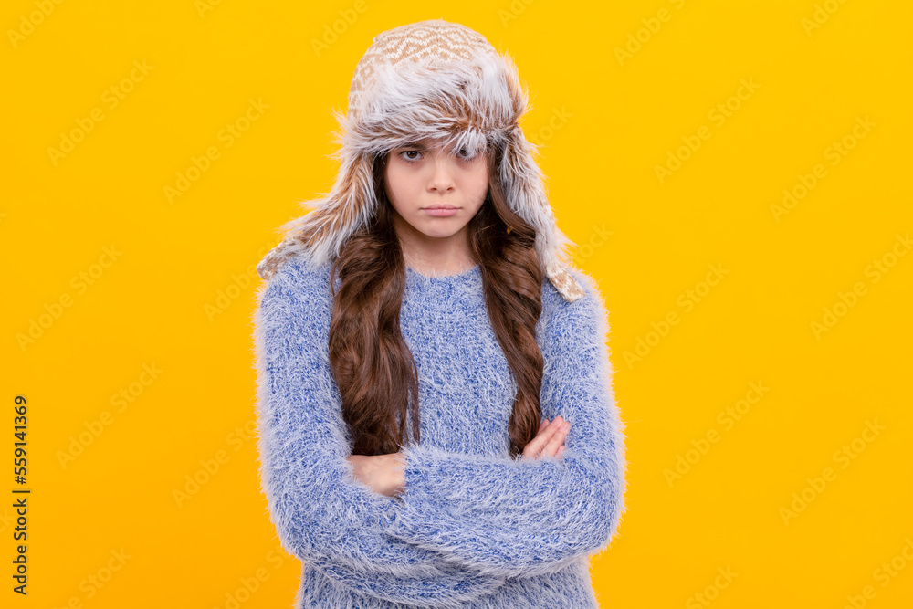 sad teen girl wear earflap hat on yellow background, season fashion
