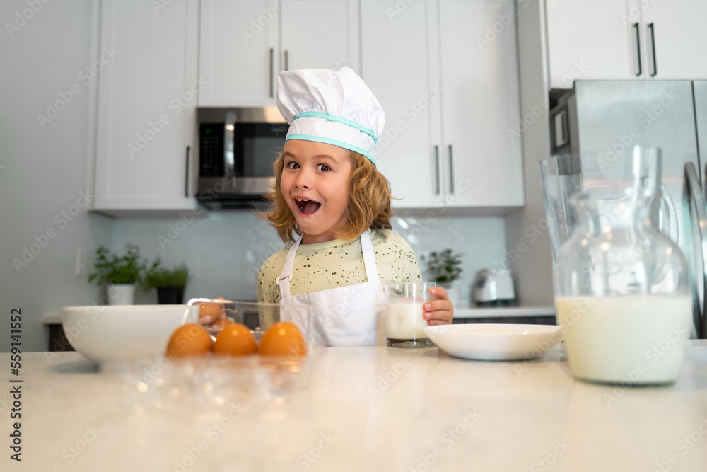 Kid chef cook cookery at kitchen. Cute boy cooking in kitchen at home kitchen. Healthy ingredients. Portrait of little child in uniform of cook. Cute child to be a chef. Kid chef cook cookery at kitchen. Cute boy cooking in kitchen at home kitchen. Healthy ingredients. Portrait of little child in uniform of cook. Cute child to be a chef.