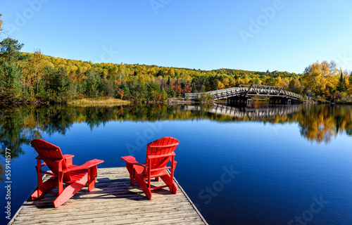Lake and red lawnchairs in fall colours