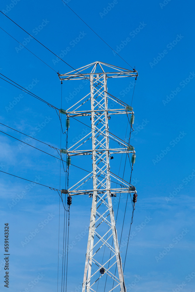 Electric power towers on the highway with blue sky on background. Countryside of Brazil Electric power towers on the highway with blue sky on background. Countryside of Brazil