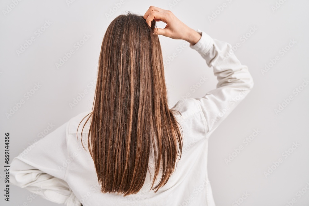 Fototapeta premium Young caucasian woman standing over isolated background backwards thinking about doubt with hand on head