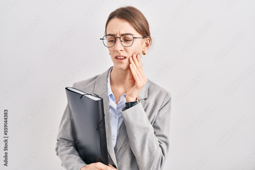 Young caucasian woman wearing business clothes and glasses touching mouth with hand with painful expression because of toothache or dental illness on teeth. dentist concept.