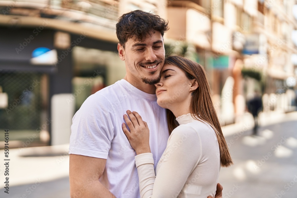 Fototapeta premium Mand and woman couple hugging each other at street