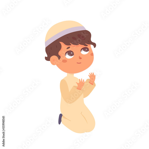 Muslim boy praying, Saudi little child in traditional hat, arab clothes sitting on knees