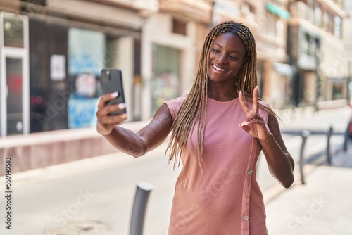 African american woman smiling confident making selfie by the smartphone at street