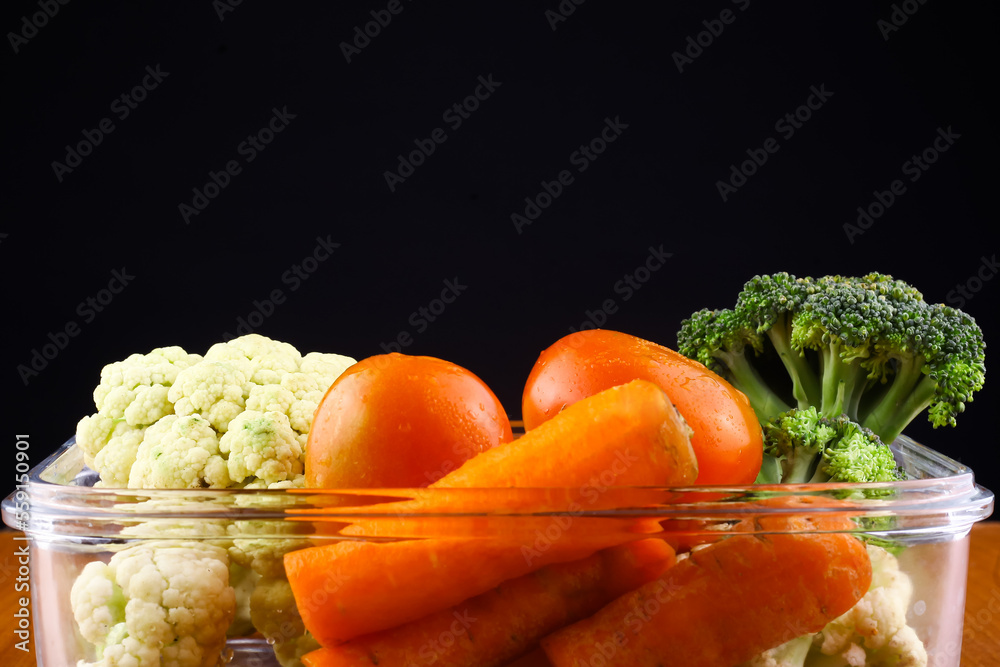 Various vegetables are in glass containers. Various vegetables are in glass containers.