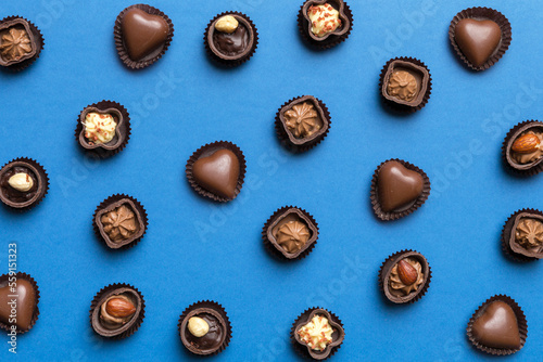 Different kinds of chocolates on colored table close-up. Top View and Flat Lay