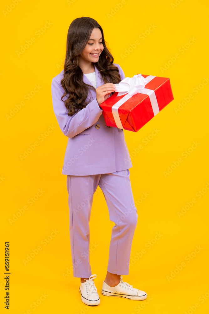 Teenager child with gift box, studio isolated background. Present for birthday, Valentines day, New Year or Christmas. Kid hold present box with gift ribbon bow. Teenager child with gift box, studio isolated background. Present for birthday, Valentines day, New Year or Christmas. Kid hold present box with gift ribbon bow.