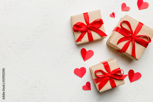 Valentine day composition  red gift box with bow and heart. Christmas present. View from above. Space for text. Holday greeting card