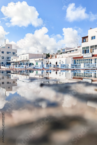 Beautiful typical white houses in front of the sea  port of Corralejo in the morning  Las Palmas Province  Fuerteventura  Canary Islands Spain