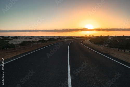 Beautiful morning on a road through the dunes. Sunrise over a road with clouds. Corralejo National Park  Canary Islands  Spain
