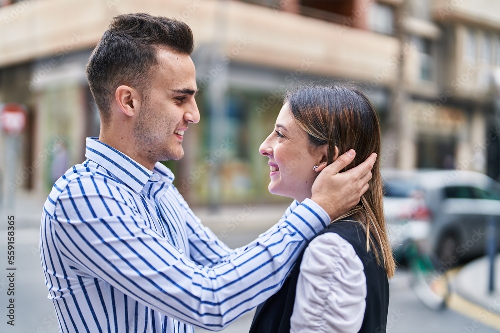 Man and woman couple smiling confident hugging each other at street Man and woman couple smiling confident hugging each other at street