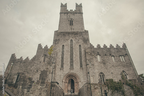 Western entrance of gothic Saint Mary's Cathedral in Limerick city, Ireland. Cloudy weather. Outdoor shot photo