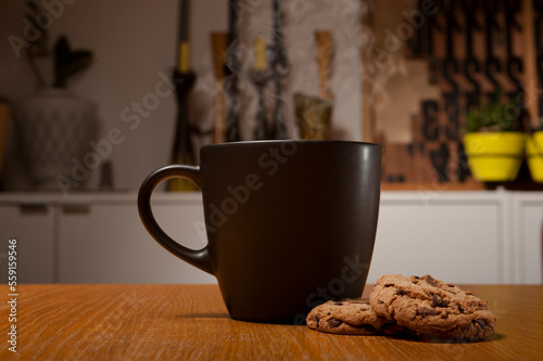 A hot Cup of Coffee or tea with cookies on a table in a creative environment 