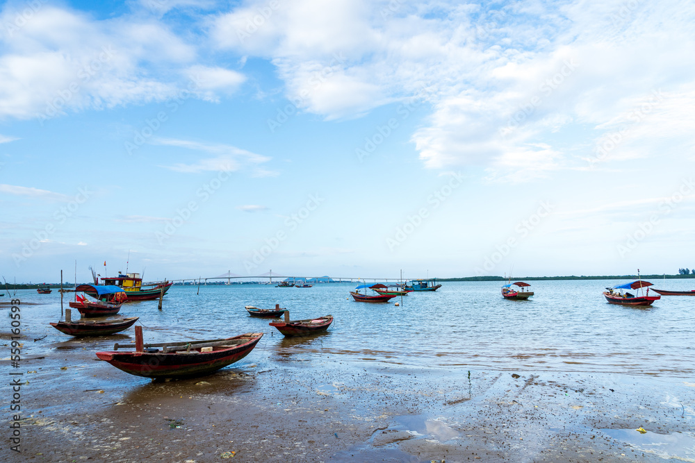 The scenery of the estuary with the bridge crossing is very beautiful, the sky is clear and the small boats are ready to go fishing The scenery of the estuary with the bridge crossing is very beautiful, the sky is clear and the small boats are ready to go fishing