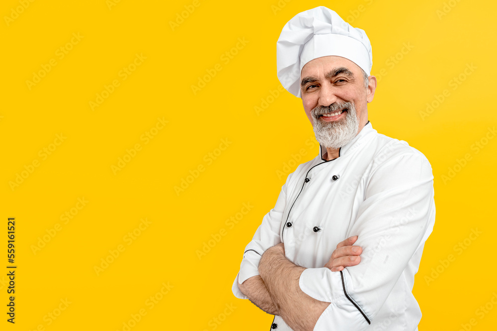 Chef-cooker in a chef's hat and jacket. Senior professional baker man wearing a chef's outfit. Character kitchener, pastry chef for advertising.
