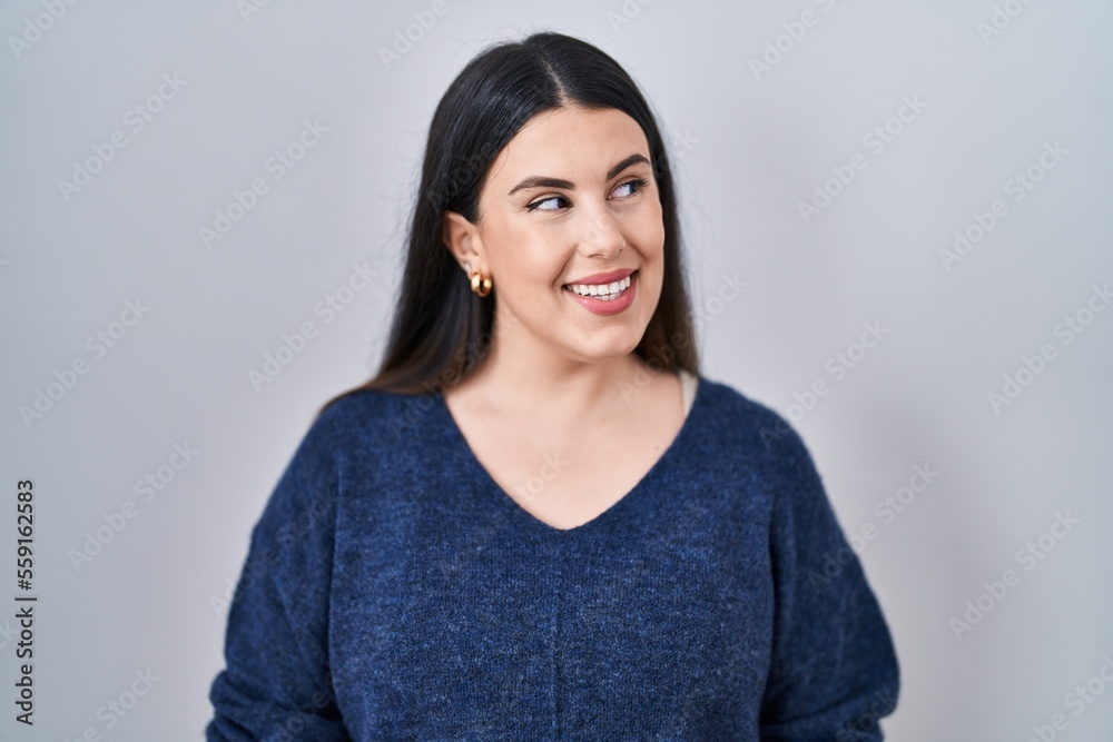 Young brunette woman standing over isolated background smiling looking to the side and staring away thinking. Young brunette woman standing over isolated background smiling looking to the side and staring away thinking.