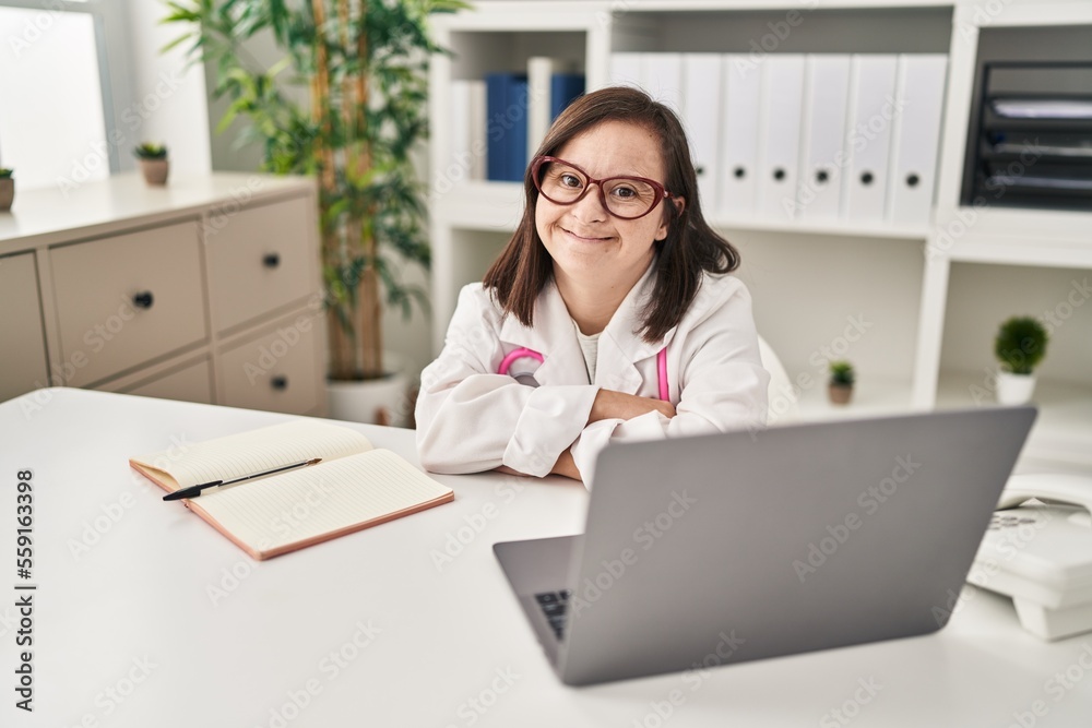 Down syndrome woman wearing doctor uniform smiling confident at clinic Down syndrome woman wearing doctor uniform smiling confident at clinic