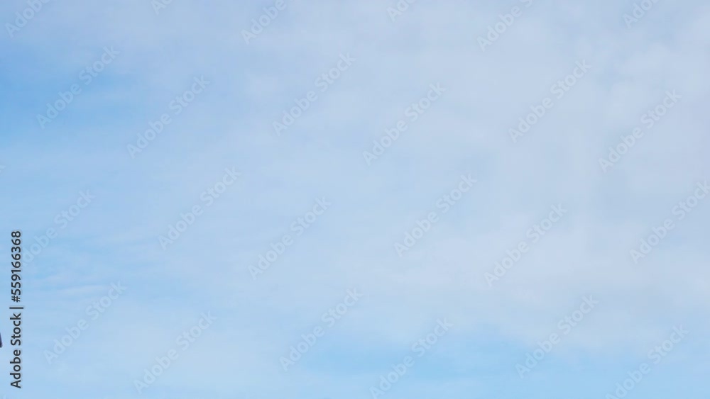 Atmosphere Blue Sky with Cirrus White Clouds, Skies, Slow Motion. Clear Sunny Skyscraper and Light White Clouds, Celestial, Heaven, Blue White Abstract Background. Atmosphere Blue Sky with Cirrus White Clouds, Skies, Slow Motion. Clear Sunny Skyscraper and Light White Clouds, Celestial, Heaven, Blue White Abstract Background.