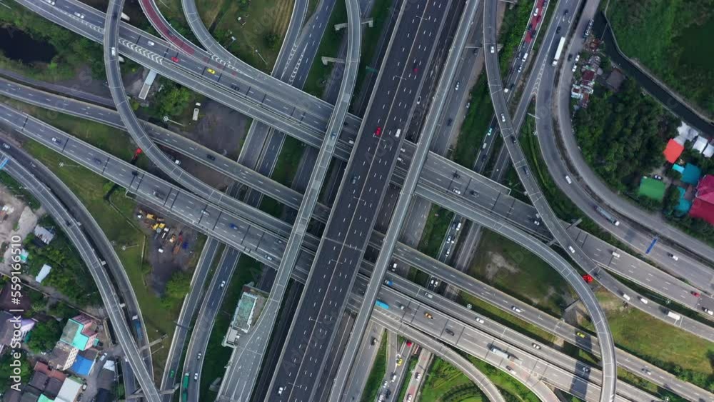 Aerial view of Multilevel junction motorway top view, Road traffic an important infrastructure in Thailand. Expressway Road and Roundabout. Transportation and travel concept. 4K Aerial view of Multilevel junction motorway top view, Road traffic an important infrastructure in Thailand. Expressway Road and Roundabout. Transportation and travel concept. 4K