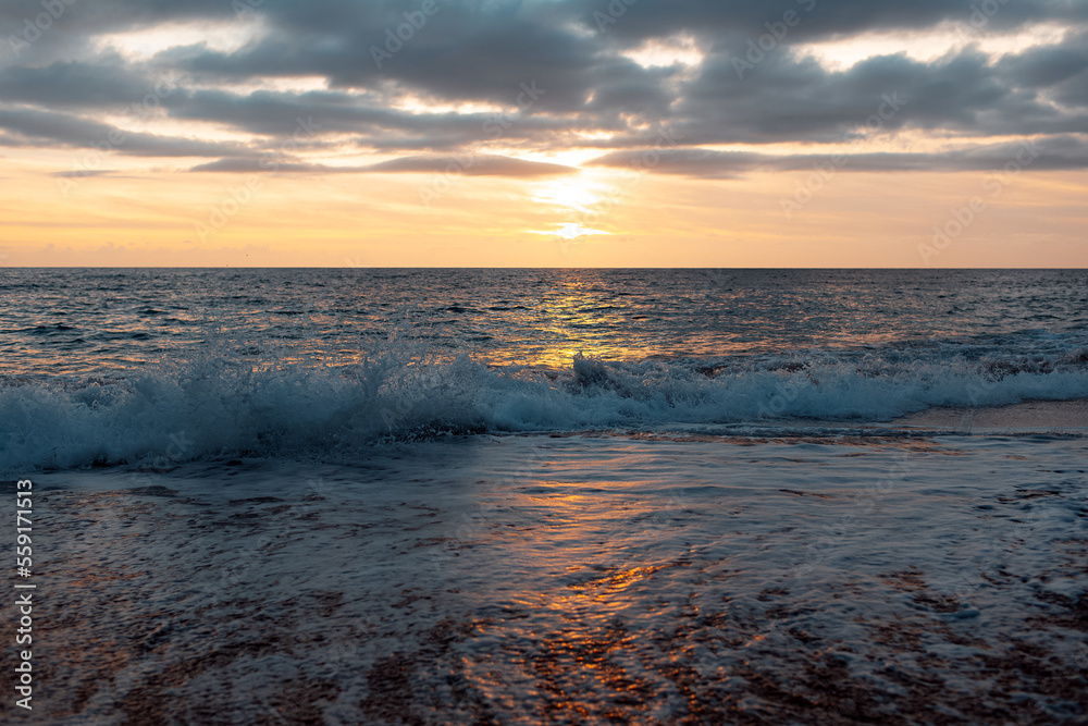 Obraz premium Natural landscape of beautiful sunset and waves of Mediterranean sea on coast of Cyprus.