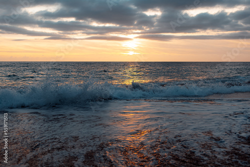 Natural landscape of beautiful sunset and waves of Mediterranean sea on coast of Cyprus.