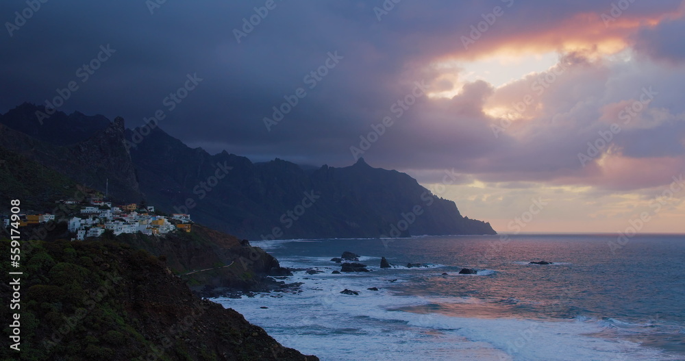 Picturesque mountain costline ocean landscape after sunset. Almaciga village on cliff. Tenerife Island.