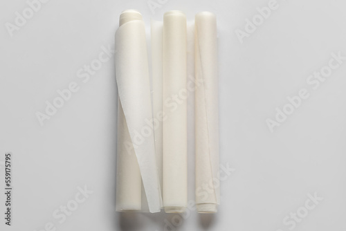Rolls of baking paper on white background