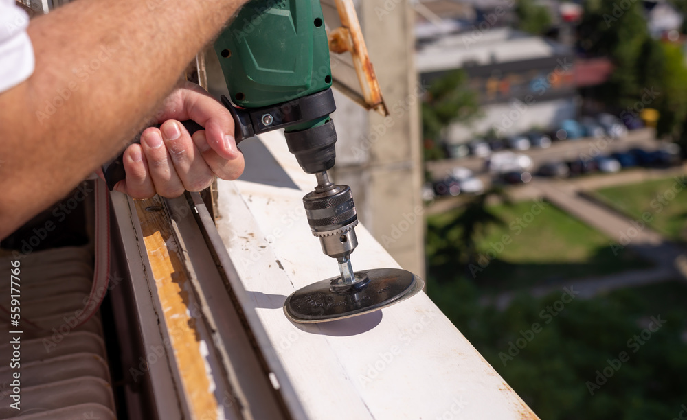 Machine during sanding rust from an old window sill