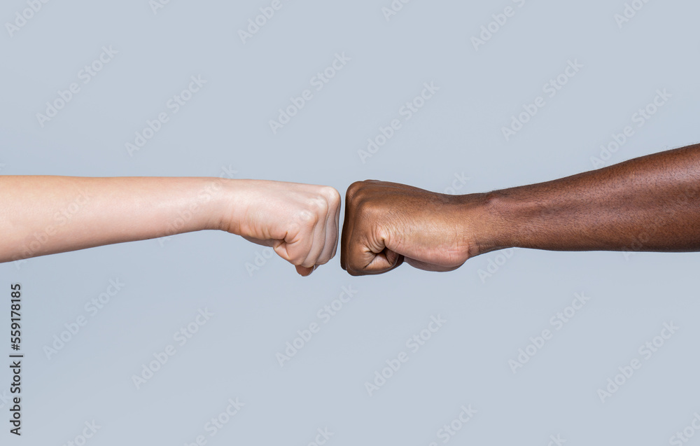 Black African American race male and woman hands giving a fist bump, multiracial diversity, immigration concept. Closeup of multicultural friends giving fist bump to each other - obrazy, fototapety, plakaty 