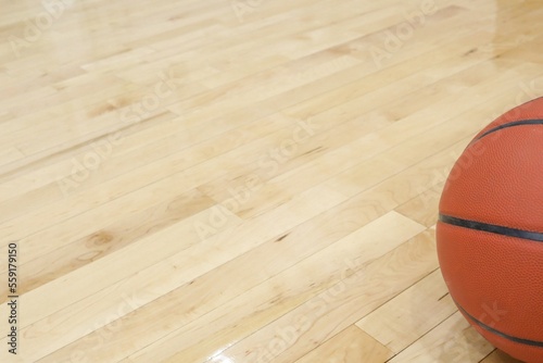 Basketball resting on wooden floor © SBaty