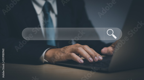 Search engine optimization(SEO) technology Concept, businessman hand typing computer with function bar to search information on website by wireless internet network