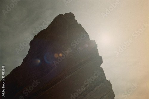 Sun flares coming from behind a mountain rock at Red Rocks. Shot on 35mm film