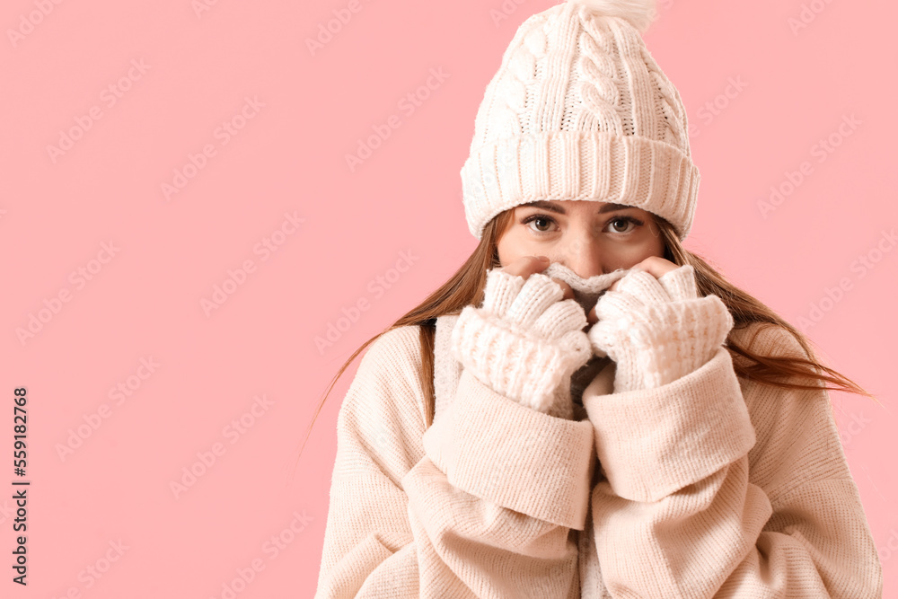 Frozen young woman in winter clothes on pink background, closeup Frozen young woman in winter clothes on pink background, closeup