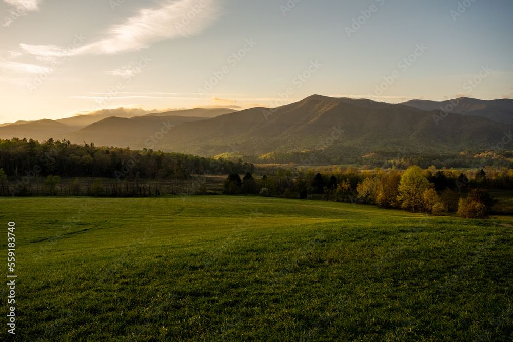 Naklejka premium Morning Sun Throws Soft Light Over Cades Cove