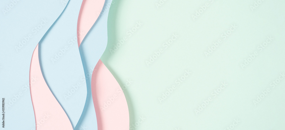 Abstract colored paper texture background. Minimal paper cut composition with layers of geometric shapes and lines in pastel green, pink and light blue colors. Top view, copy space