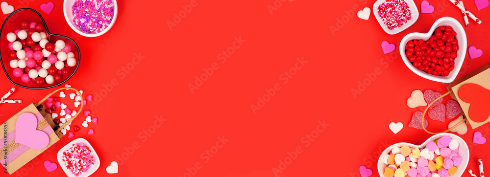 Valentines Day candy double border with a variety of sweets. Above view on a red paper banner background with copy space. Valentines Day candy double border with a variety of sweets. Above view on a red paper banner background with copy space.