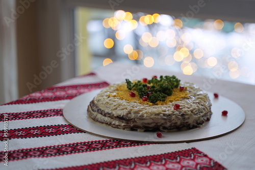 Obraz na płótnie Homemade layered liver cake. Traditional Ukrainian food on the table with embroidered tablecloth. w salonie