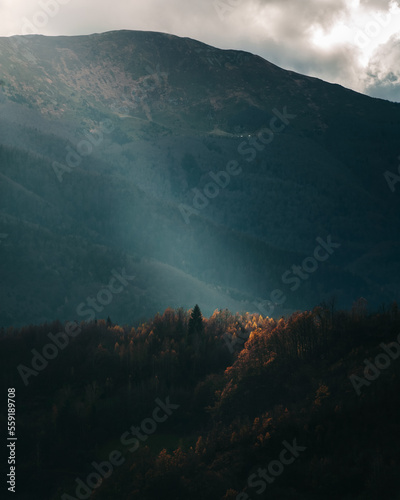 Single sun ray hitting the landscape during autumn